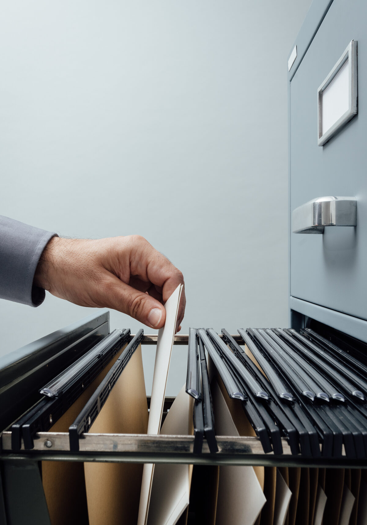 industrial agreements paperwork being pulled by person in office